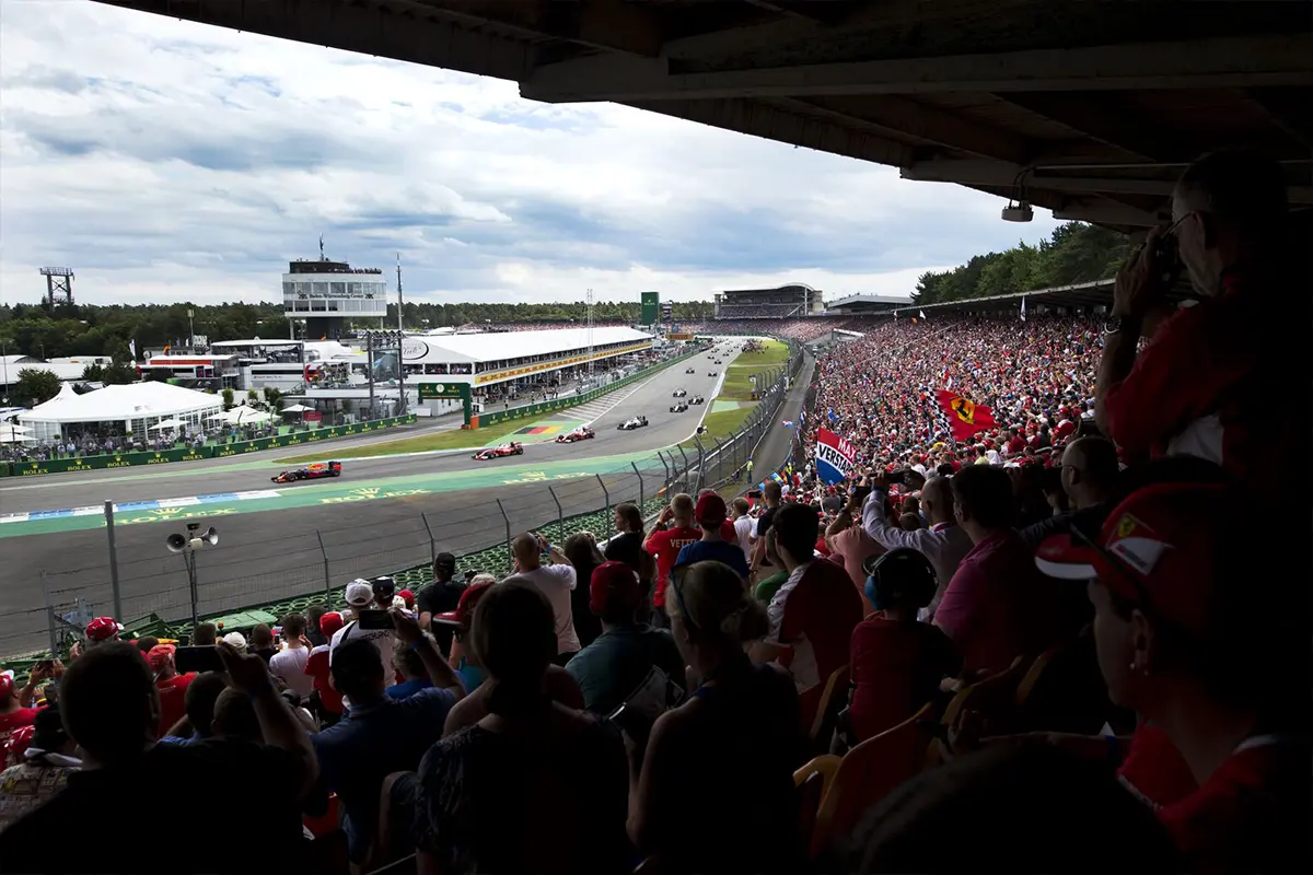 People on a curved stand watching MADRING